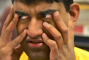 Tejus Sharathchandra, 20, reacts as he folds letters at the Vocational Training Center of Western Psychiatric Institute and Clinic of UPMC on the South Side.